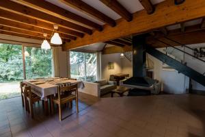 a dining room with a table and a fireplace at Gîte le tuc d'esparre in Orist