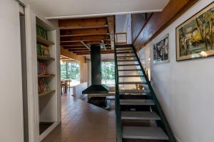 a spiral staircase in a house with a fireplace at Gîte le tuc d'esparre in Orist