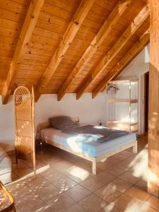 a bed in a room with a wooden ceiling at Ferienwohnung Kern in Goldkronach