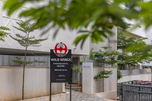 a sign in front of a building at Wild Wings Hotel Narsingi in Hyderabad