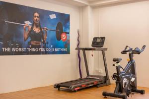 a gym with two exercise bikes and a poster on the wall at Wild Wings Hotel Narsingi in Hyderabad