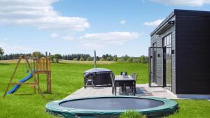 a backyard with a pool and a playground at Villavilla 604 - Gjerrild, Østjylland in Grenå