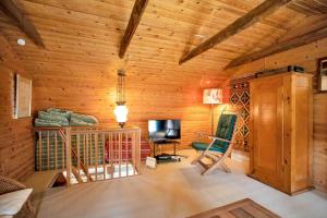 a living room with wooden walls and a television in a cabin at 10081B-Rorvig-Skansehagevej-32 in Rørvig
