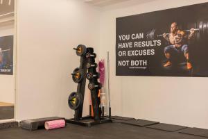 a gym with a sign on the wall and a gym at Wild Wings Hotel Narsingi in Hyderabad