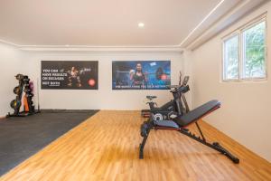 a room with a gym with a exercise bike at Wild Wings Hotel Narsingi in Hyderabad +15 photos