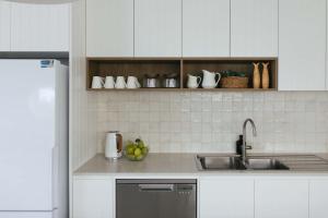 a kitchen with a sink and a counter top at La Ronde Three - Unit 3 - Oceanstays in Yamba +34 photos