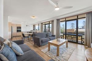 a living room with a couch and a table at Akuna 14, 6 Joffre Street in Port Macquarie