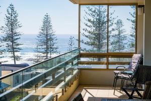 a balcony with chairs and a view of the ocean at Akuna 14, 6 Joffre Street in Port Macquarie