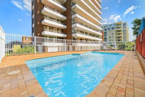 a swimming pool in front of a building at Akuna 14, 6 Joffre Street in Port Macquarie