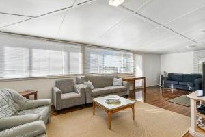 a living room with couches and a coffee table at Almare, 7 Gowing Street in Crescent Head