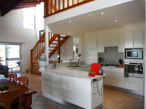 a kitchen with a white island in a room at Bellevue Holiday House Crescent Head in Crescent Head