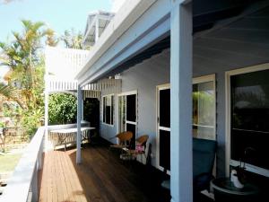 a porch of a house with chairs on it at Bellevue Holiday House Crescent Head in Crescent Head