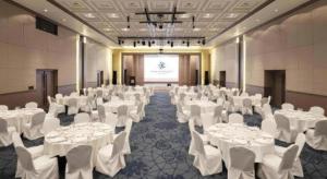 a banquet hall with white tables and white chairs at Saipan World Resort in Susupe +126 photos