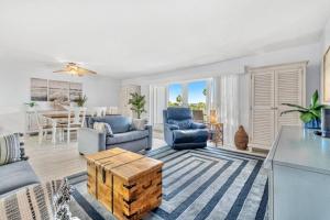 a living room with a couch and chairs and a table at Escape to Beach Oasis! Family Friendly, Updated Beachside Condo with Heated Pool! in Clearwater Beach