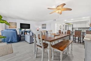 a dining room and living room with a table and chairs at Escape to Beach Oasis! Family Friendly, Updated Beachside Condo with Heated Pool! in Clearwater Beach +39 photos