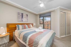 a bedroom with a bed and a window at Flightdeck 301, Clarence Street in Port Macquarie +12 photos