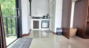 a living room with a door open to a kitchen at Lantanoblesse in Ko Lanta +108 photos
