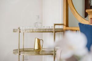 a gold shelf with a tea kettle on it at Historic Huntingdon House in Wauchope +41 photos