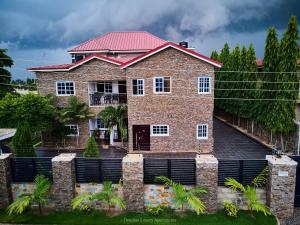 a large brick house with a red roof at Douglas Luxury Apartments - Douglas Court in Trofwi