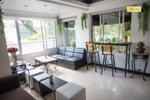 a living room with a couch and a bar at EASTAN VIEW in Chiang Mai