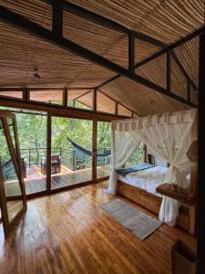 a bedroom with a bed and a hammock in it at SeTena Tierra Humeda Ecolodge in Minca