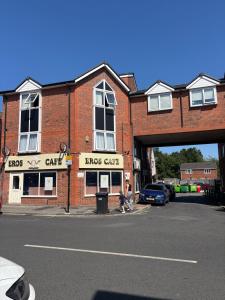 a large brick building with a bridge over a street at Modern 1-Bed Flat in Wigan in Wigan
