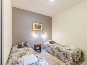 a room with two beds and a table at Holiday Home Yllästar 3 as 508 by Interhome in Äkäslompolo