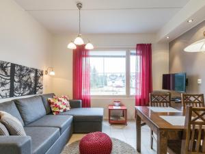 a living room with a couch and a table at Holiday Home Yllästar 3 as 508 by Interhome in Äkäslompolo