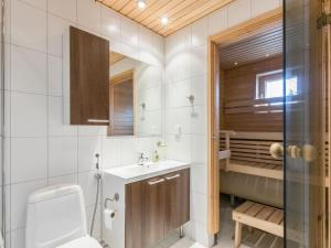 a bathroom with a toilet and a sink at Holiday Home Yllästar 3 as 508 by Interhome in Äkäslompolo