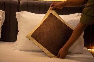a person is making a triangle on a bed at Hotel Las Vegas in Jaipur