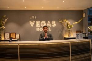 a man standing behind a counter in a store at Hotel Las Vegas in Jaipur