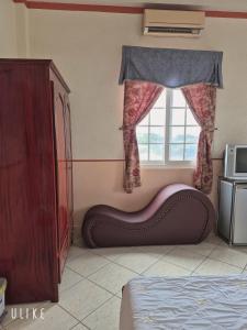 a bedroom with a bed in front of a window at Khách sạn Nam Sơn in Ấp Lợi Ðủ