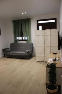 a living room with a couch and a table at Los Llanos Loft & Suites in Manzanilla +3 photos