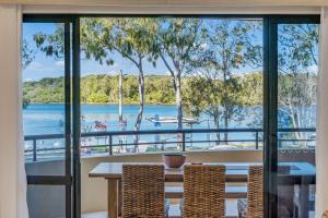 a dining room with a view of the water at Pippies, your water view escape in North Haven