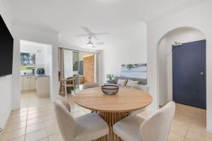 a dining room and living room with a table and chairs at Relax at Flynn s View in Port Macquarie
