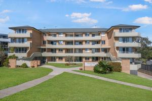 an apartment building with a lawn in front of it at Relax at Flynn s View in Port Macquarie