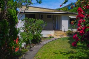 a house with a garden and flowers in the yard at Rosemaree, 24 East Street in Crescent Head