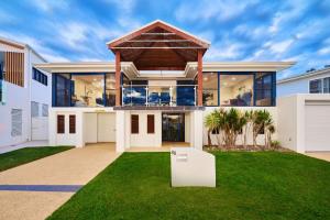 a large white house with a roof at Riverside Luxury in Port Macquarie