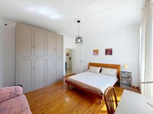 a bedroom with a bed and a couch at Apartment Ca dei Noni by Interhome in Riva del Garda