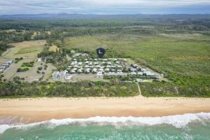 an aerial view of a resort on the beach at Sandy Shores, Serenity Resort in Diamond Beach