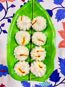 a plate of food on a green leaf at Shree Kelbai Homestay in Malvan