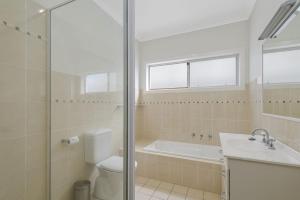 a bathroom with a toilet and a sink and a shower at Vaka Malua, 7 Scott Street in Crescent Head +11 photos