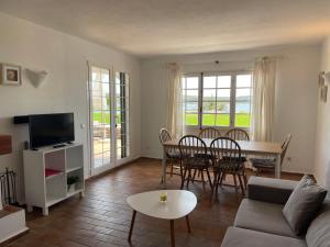 a living room with a couch and a table at Es CASTELL 03 by SOM Menorca in Fornells