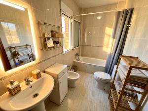 a bathroom with a sink and a toilet and a mirror at Casa rural Lomalinda in Granada +36 photos