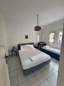 a bedroom with a large bed and a couch at Serene appartment at St. Ioannis in Agios Ioannis Pelio