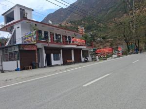 a building sitting on the side of a road at Hotel Kalyan Palace And Restaurant in Pīpalkoti