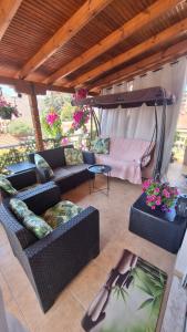 an outdoor living room with couches and a table at Persefoni 's hause 1 in Nea Kallikrateia