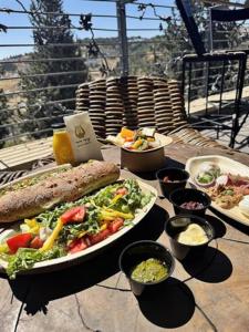 a table with several plates of food on a table at City of David - Boutique Stay by the Western Wall in Jerusalem