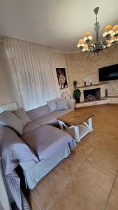 a bedroom with a large bed and a table at Persefoni 's hause 1 in Nea Kallikrateia