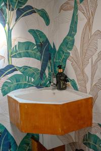 a bathroom with a sink with a leafy wallpaper at Rivers End Farm Stanford - Cabins in Stanford +81 photos